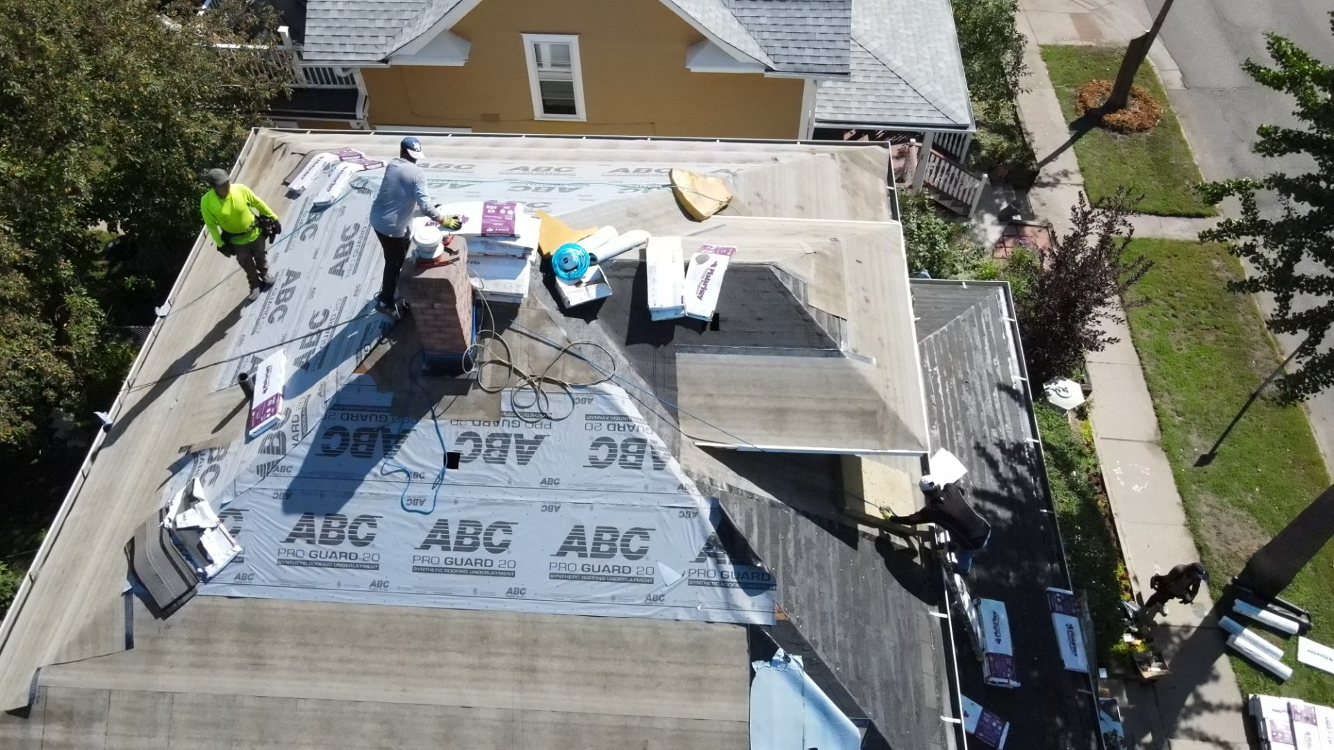 Sellers Roofing crew installing synthetic underlayment on a Twin Cities home — aerial view