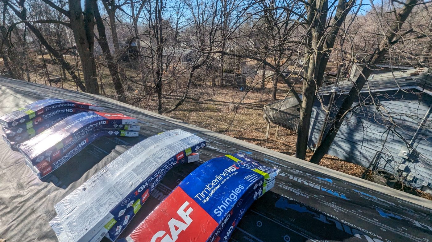 GAF Timberline HD shingle bundles staged on a Twin Cities roof deck